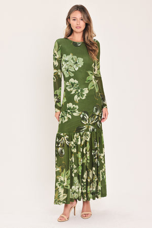 A woman modeling a long-sleeve power mesh maxi dress with a moss green and white tropical floral print | Flying Tomato