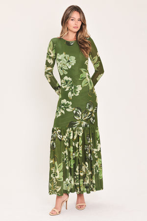 A woman modeling a long-sleeve power mesh maxi dress with a moss green and white tropical floral print | Flying Tomato