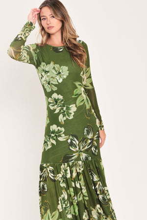 A woman modeling a long-sleeve power mesh maxi dress with a moss green and white tropical floral print | Flying Tomato