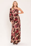 A woman modeling a one-shoulder maxi dress with a bold abstract swirl pattern in burgundy, brown, and beige | Flying Tomato