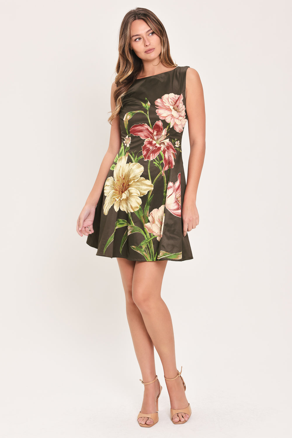 Woman wearing a sleeveless dark brown mini dress with a beige, pink, and burgundy floral print | Flying Tomato