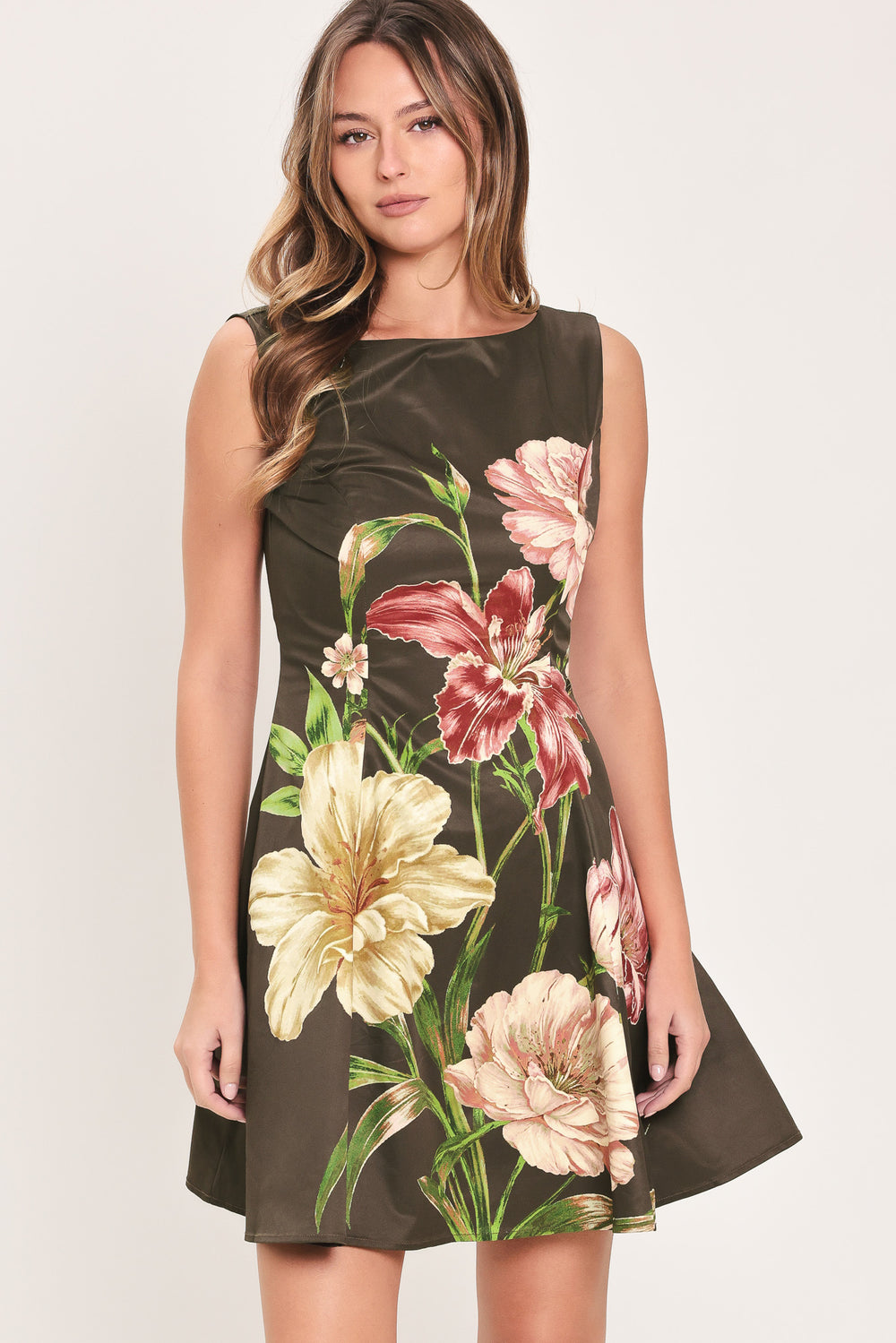 Woman wearing a sleeveless dark brown mini dress with a beige, pink, and burgundy floral print | Flying Tomato