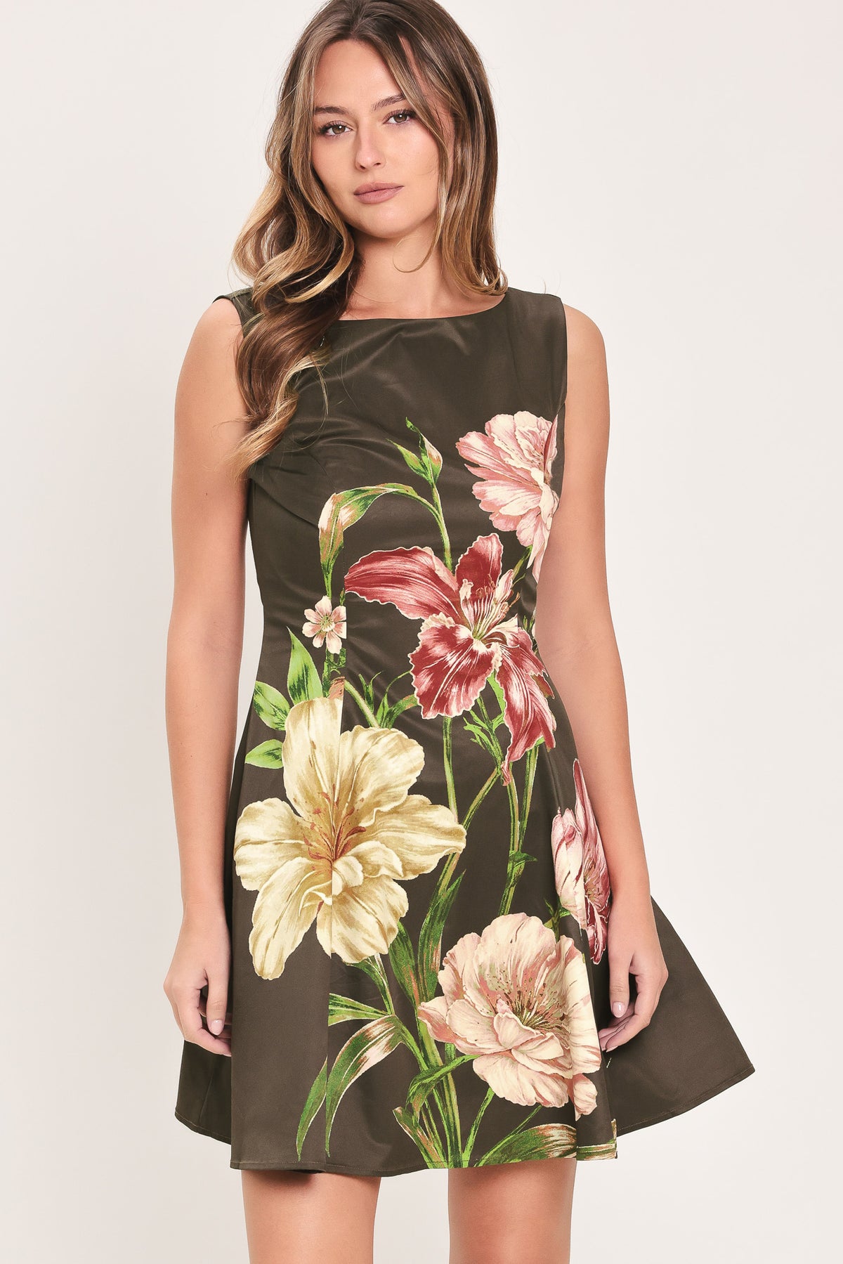 Woman wearing a sleeveless dark brown mini dress with a beige, pink, and burgundy floral print | Flying Tomato