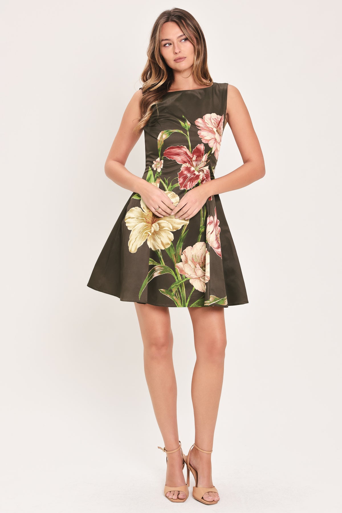 Woman wearing a sleeveless dark brown mini dress with a beige, pink, and burgundy floral print | Flying Tomato