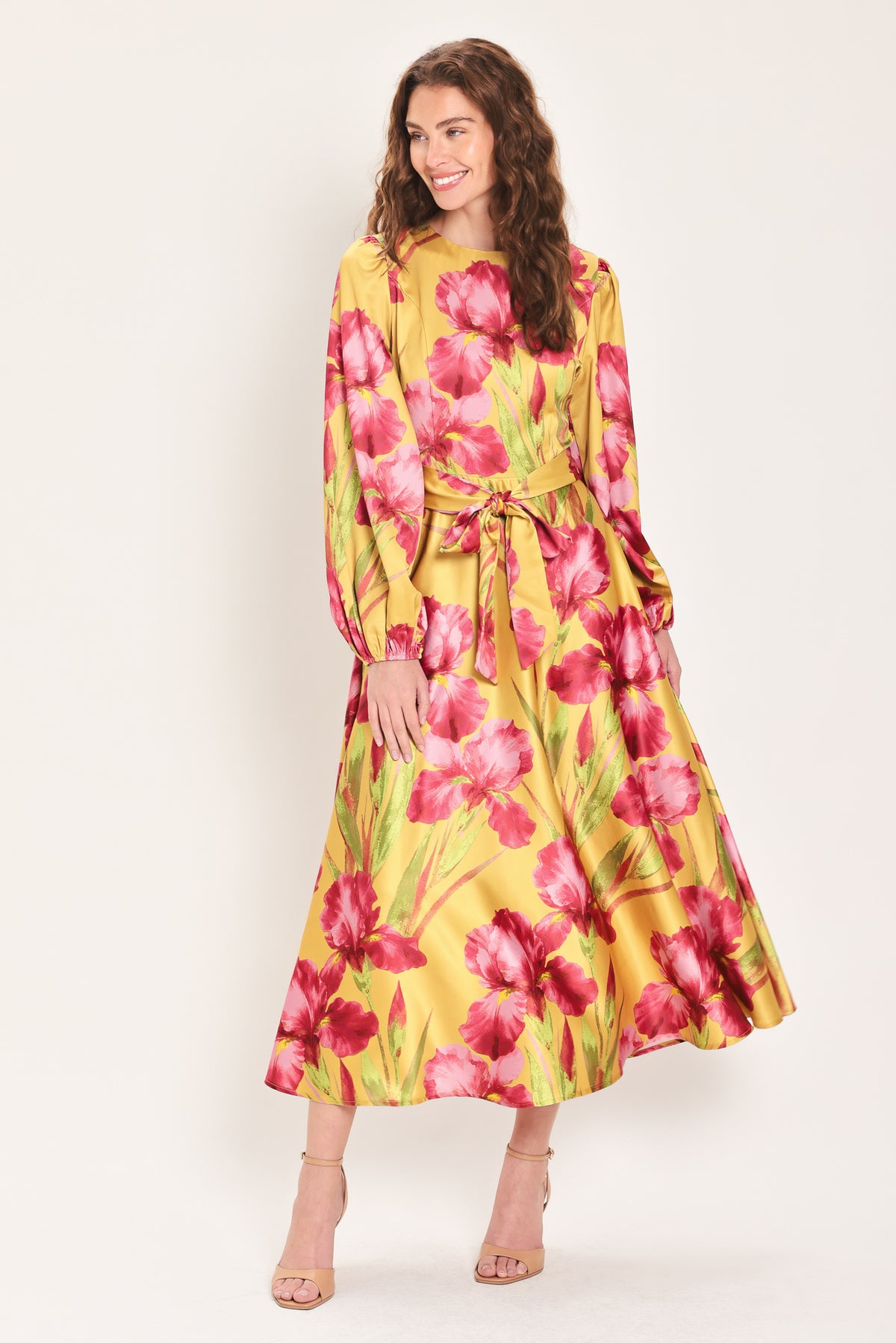 Woman wearing a long sleeve golden yellow midi dress with pink florals printed and self tie waist belt | Flying Tomato
