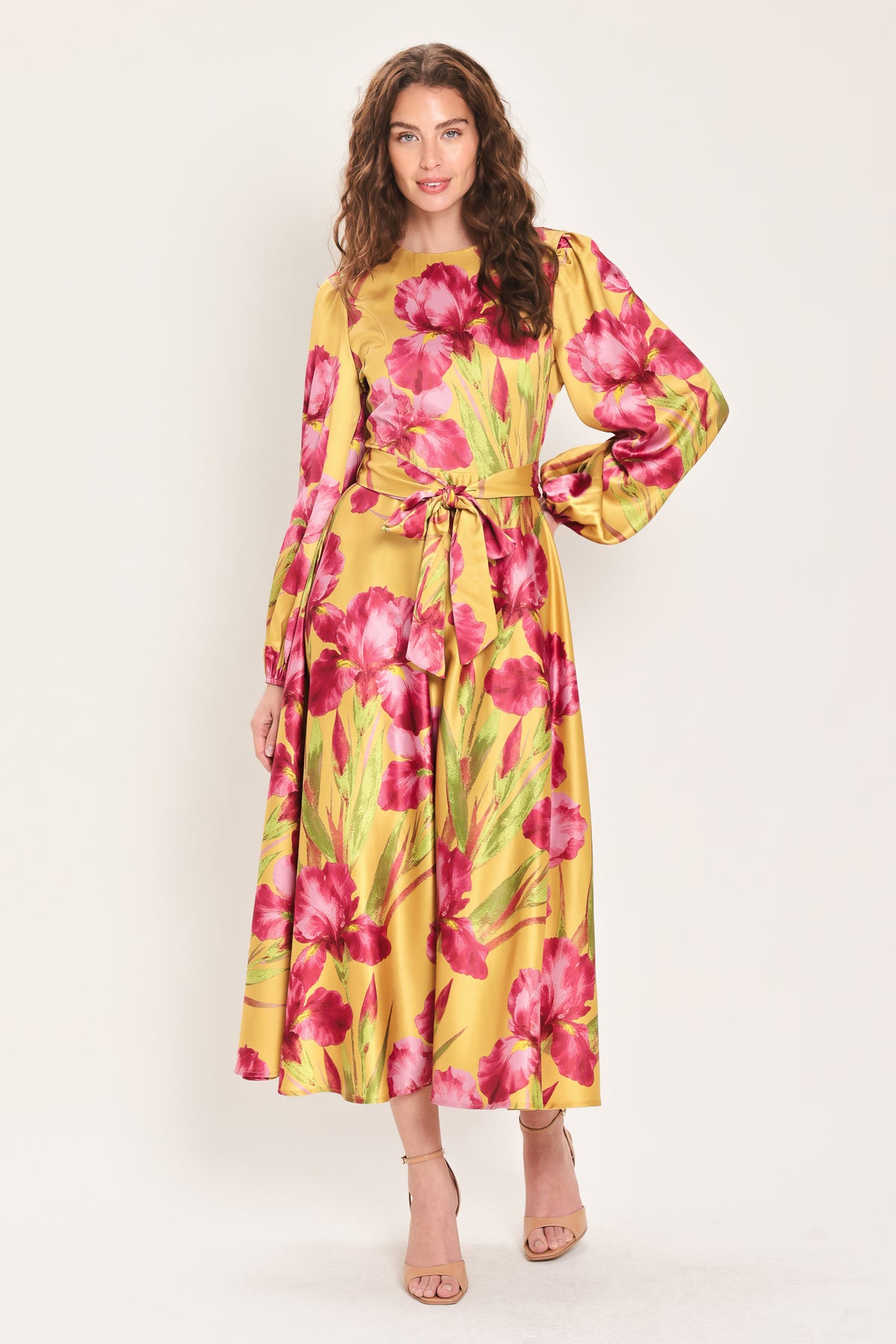 Woman wearing a long sleeve golden yellow midi dress with pink florals printed and self tie waist belt | Flying Tomato