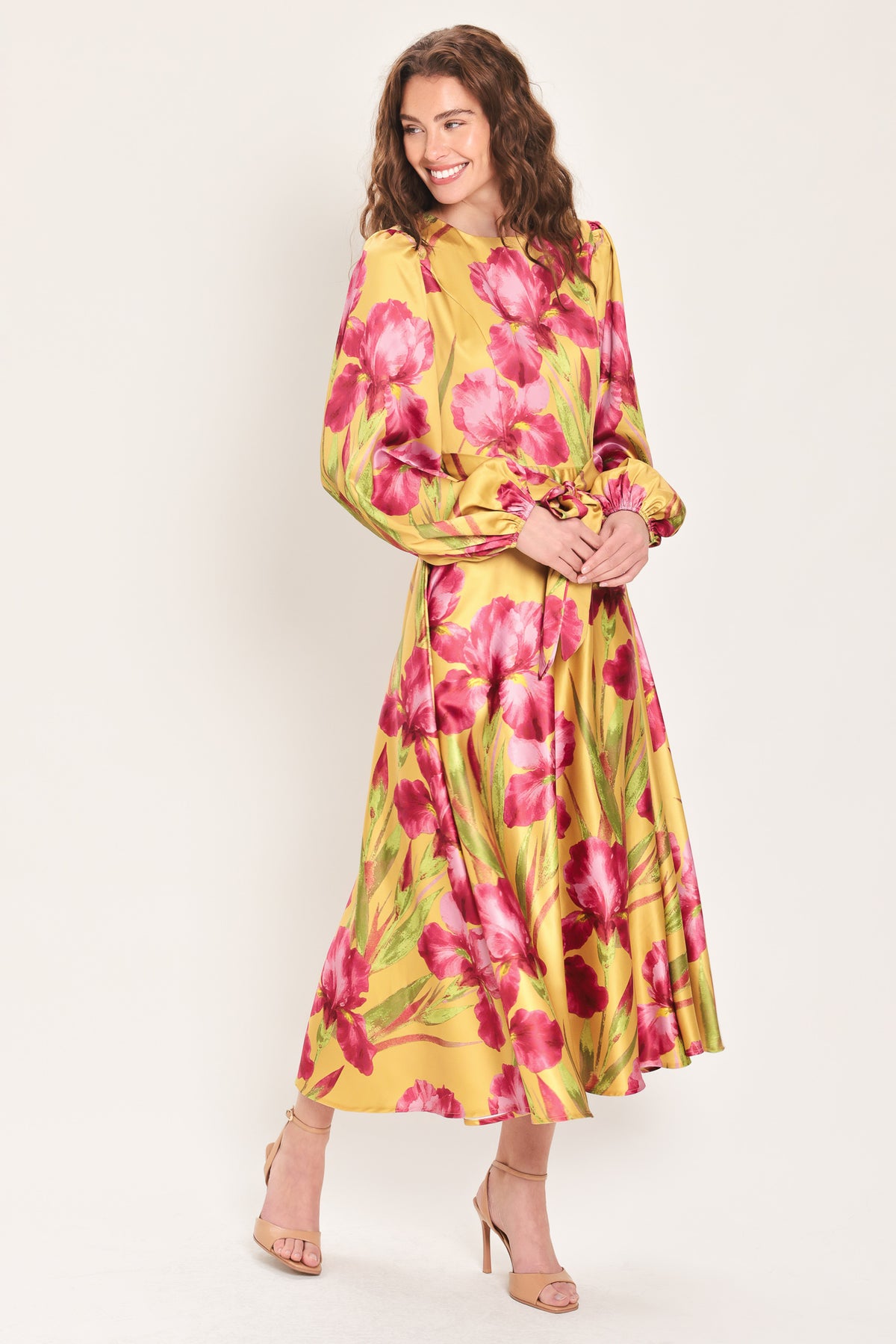 Woman wearing a long sleeve golden yellow midi dress with pink florals printed and self tie waist belt | Flying Tomato