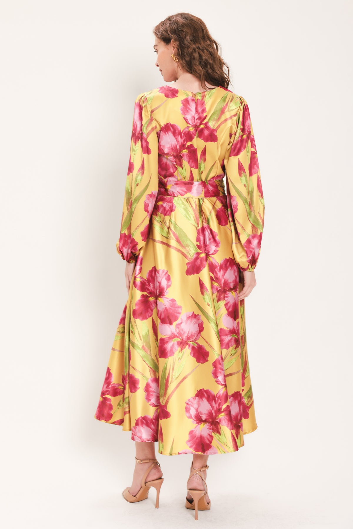 Woman wearing a long sleeve golden yellow midi dress with pink florals printed and self tie waist belt | Flying Tomato