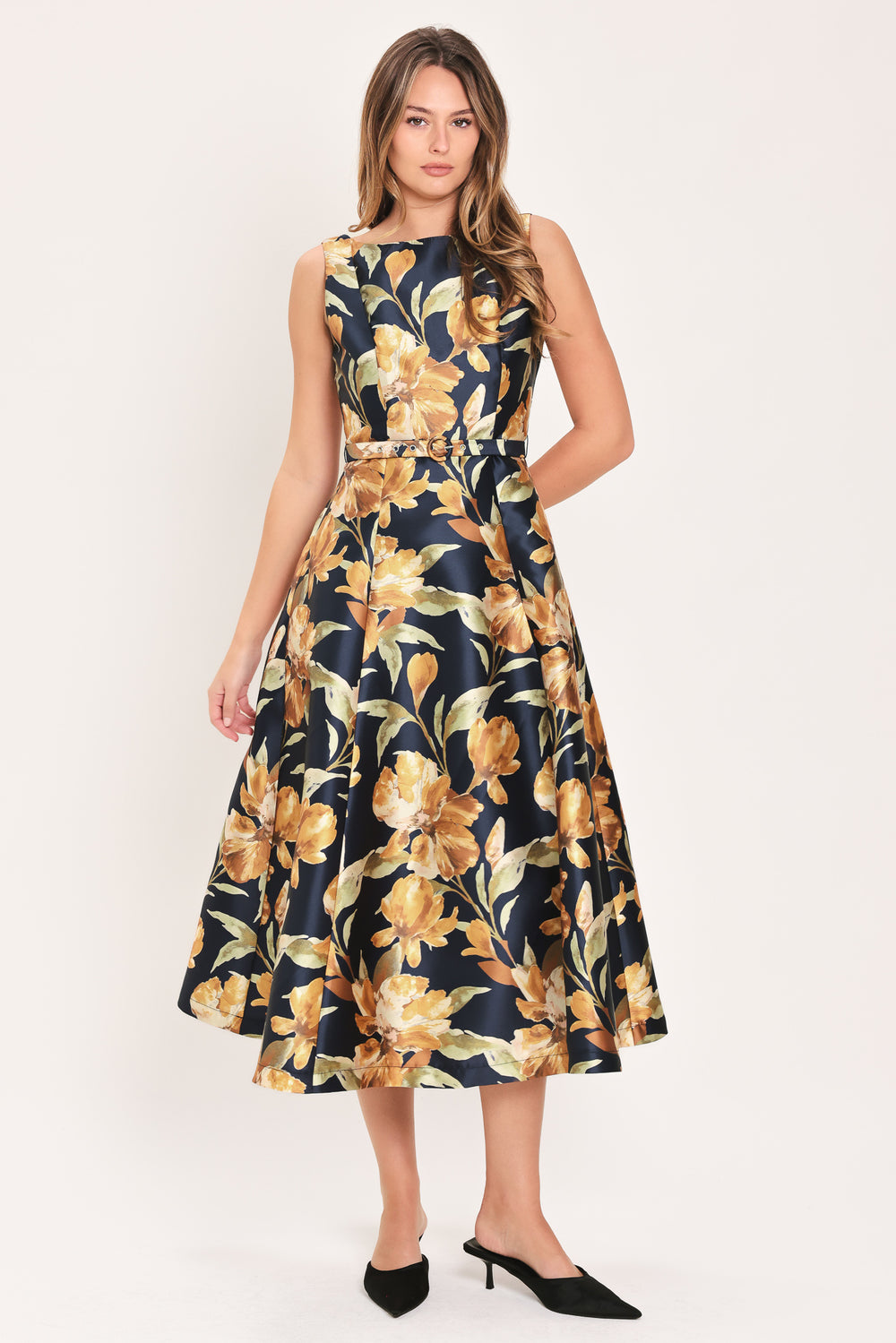 Woman wearing a sleeveless navy midi dress with orange floral pattern and matching belt | Flying Tomato