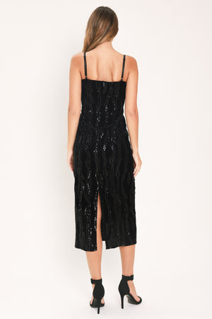 A woman modeling a black sequined midi dress with spaghetti straps and a black lace sweetheart neckline | Flying Tomato