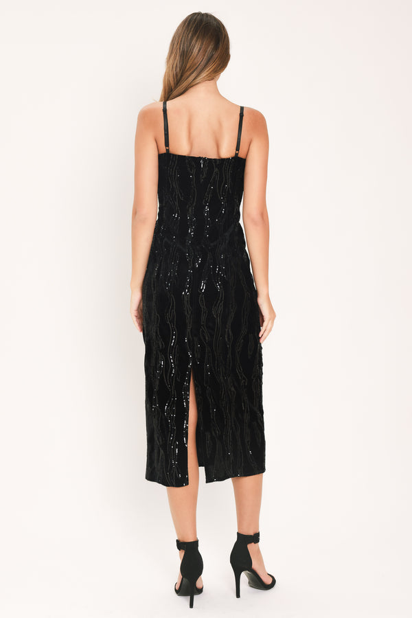 A woman modeling a black sequined midi dress with spaghetti straps and a black lace sweetheart neckline | Flying Tomato