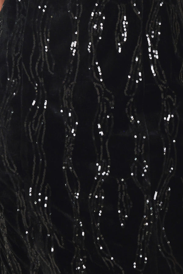 A woman modeling a black sequined midi dress with spaghetti straps and a black lace sweetheart neckline | Flying Tomato