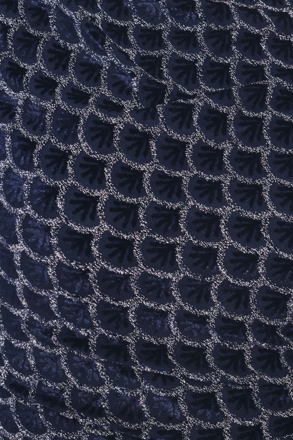 Woman wearing a long sleeve navy blue velvet midi dress with a fish scale pattern outlined with embellishments | Flying Tomato