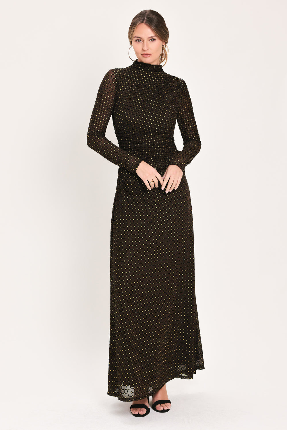 Woman wearing a long sleeve dark brown mesh maxi dress with gold tone rhinestones | Flying Tomato