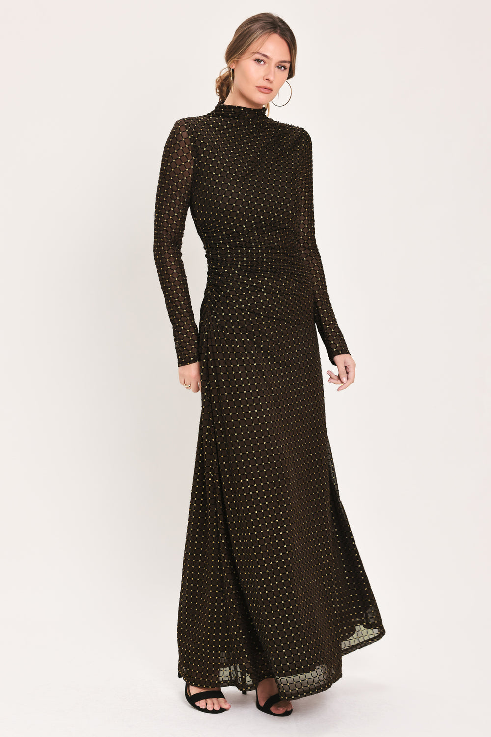 Woman wearing a long sleeve dark brown mesh maxi dress with gold tone rhinestones | Flying Tomato