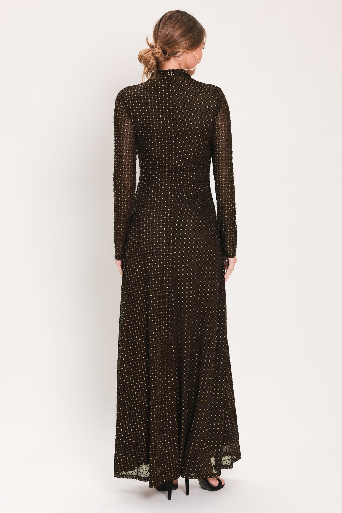 Woman wearing a long sleeve dark brown mesh maxi dress with gold tone rhinestones | Flying Tomato