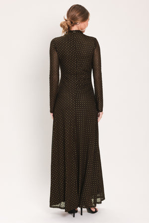 Woman wearing a long sleeve dark brown mesh maxi dress with gold tone rhinestones | Flying Tomato