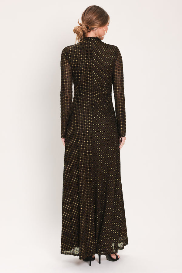 Woman wearing a long sleeve dark brown mesh maxi dress with gold tone rhinestones | Flying Tomato