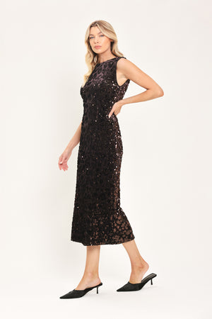 A woman modeling a sleeveless dark brown midi dress covered in shimmering sequins | Flying Tomato