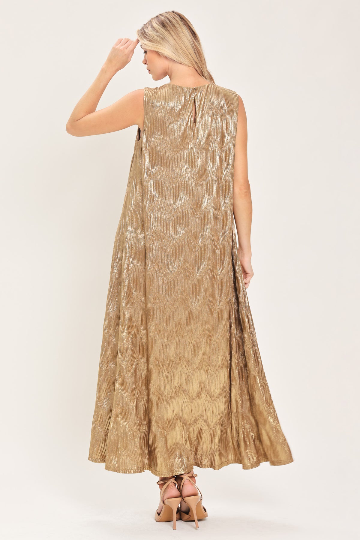 Woman wearing a sleeveless gold metallic like midi dress with dark brown suede waist belt | Flying Tomato