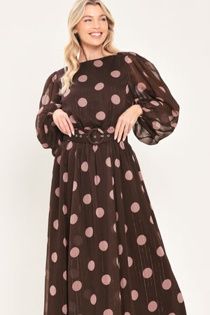 A woman modeling a brown midi dress with a pink polka dot pattern, long sheer sleeves, and a matching belt | Flying Tomato