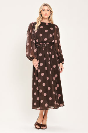 A woman modeling a brown midi dress with a pink polka dot pattern, long sheer sleeves, and a matching belt | Flying Tomato