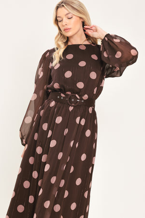 A woman modeling a brown midi dress with a pink polka dot pattern, long sheer sleeves, and a matching belt | Flying Tomato