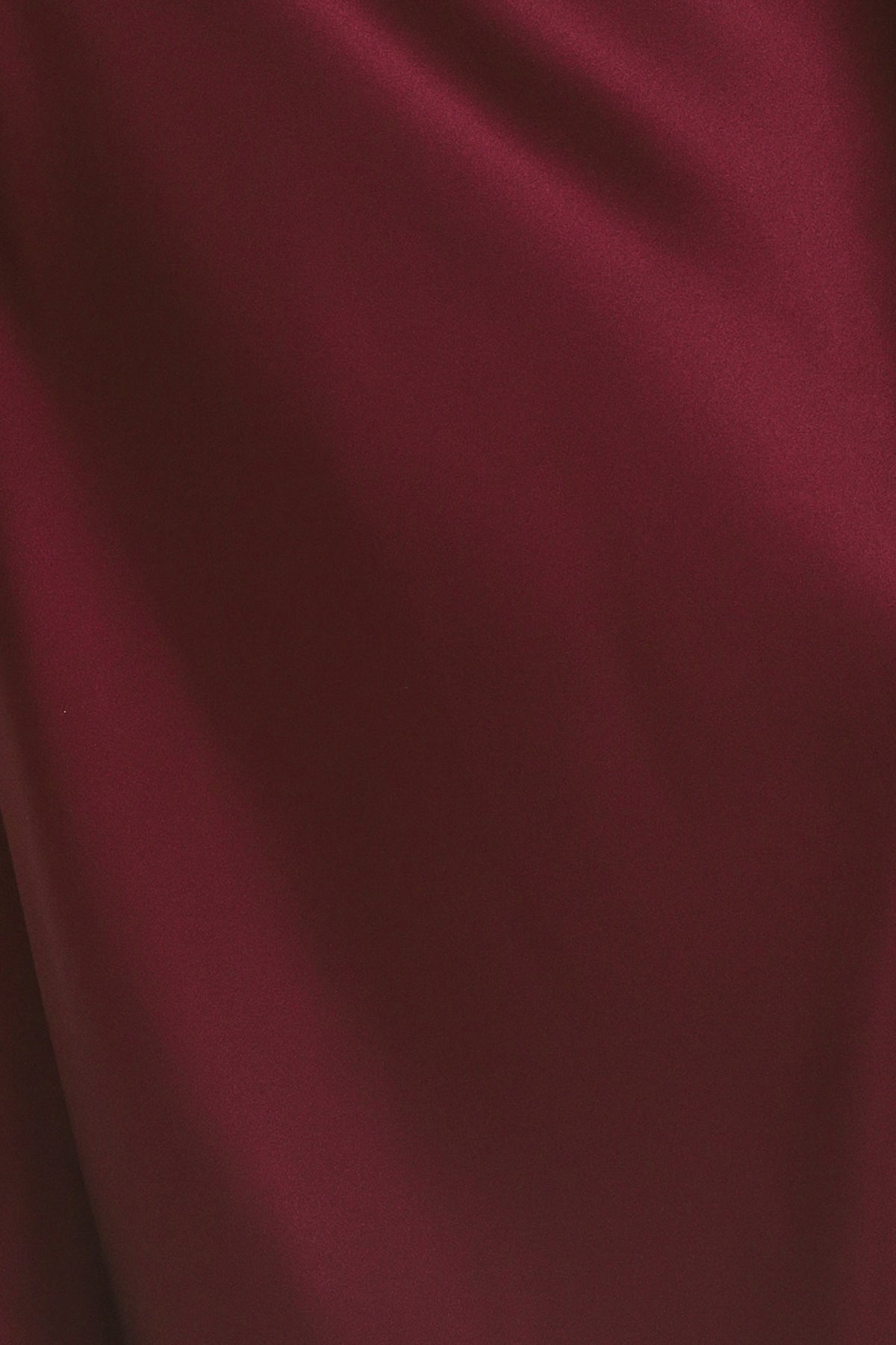 A woman modeling a floor-length maxi draped satin gown in deep burgundy wine, featuring an asymmetrical draped neckline and one sleeve | Flying Tomato