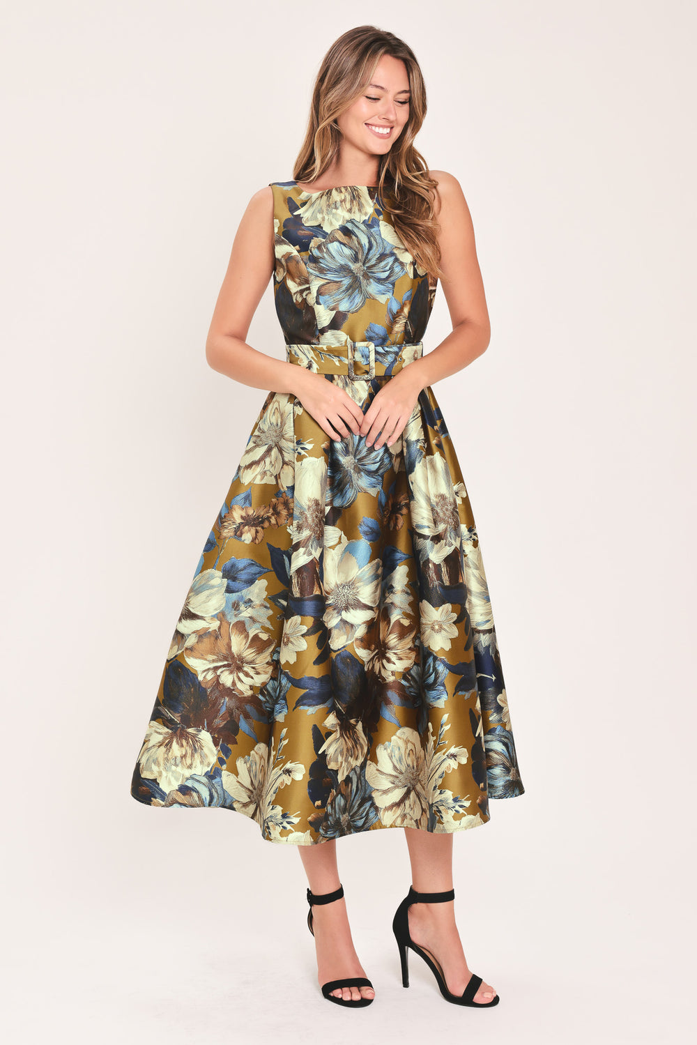 A woman modeling a sleeveless midi dress with a floral print in olive green, navy blue, beige, and white | Flying Tomato