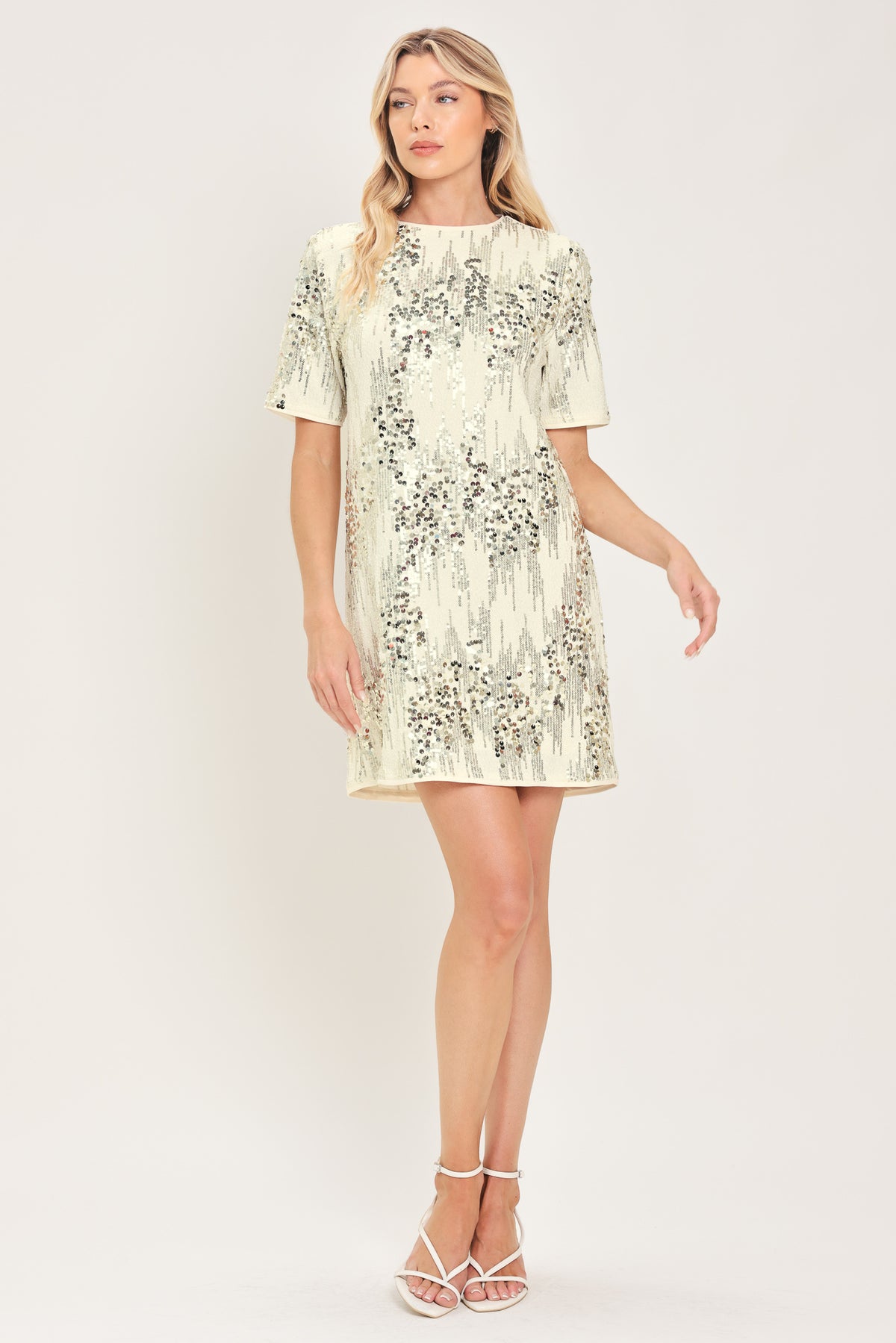 A woman modeling a short-sleeve cream sequined mini dress | Flying Tomato