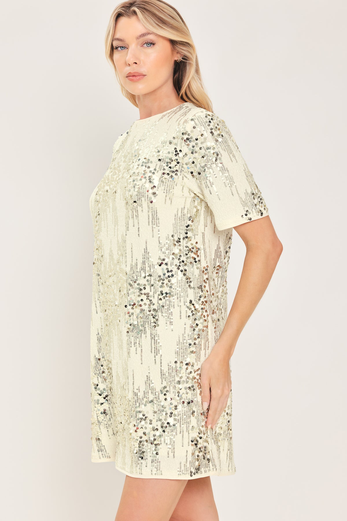 A woman modeling a short-sleeve cream sequined mini dress | Flying Tomato