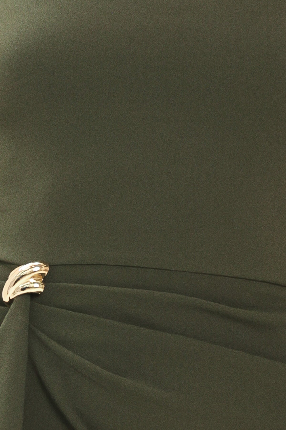 Woman wearing a long sleeve olive green mini dress with gathered fabric around the lower abdomen and fabric draping from a gold hardware a the corner of the waist | Flying Tomato