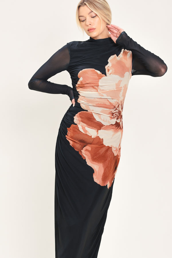 A woman modeling a black long-sleeve mock-neck mesh midi dress with a large abstract floral print in brown, beige, and white on the front | Flying Tomato