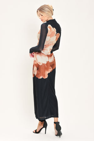 A woman modeling a black long-sleeve mock-neck mesh midi dress with a large abstract floral print in brown, beige, and white on the front | Flying Tomato