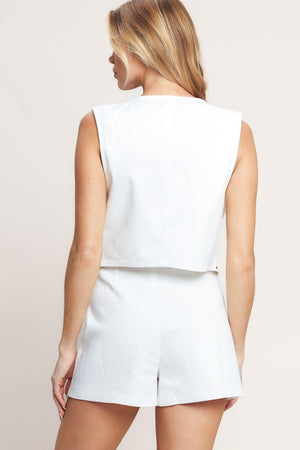 A solid woven vest featuring embroidery, stud embellishment and open front. Matching skort IP9121T

Details:

Self: 97% Cotton 3% Spandex

Size & Fit

-Model is 5`8" And Wearing Size Small
-Measurements Taken From Size Small
-Approx. Length: 20"