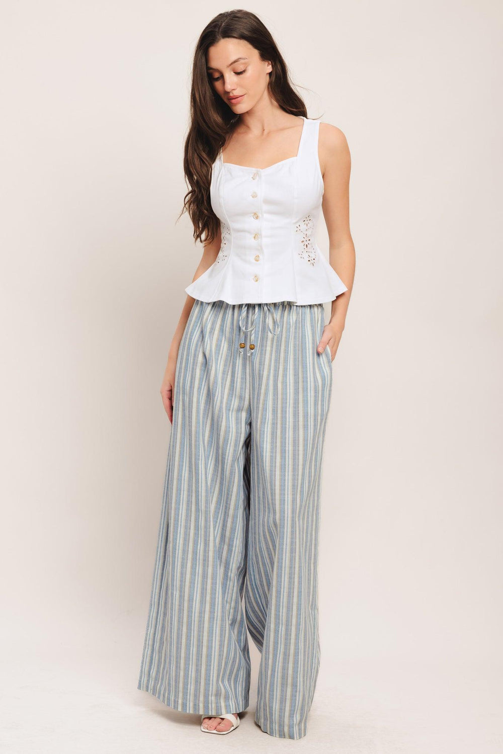 A solid top featuring sweetheart neckline, sleeveless, front button down and embroidered eyelet detail

Details:

Self: 97% Cotton 3% Spandex

Size & Fit

-Model is 5`8" And Wearing Size Small
-Measurements Taken From Size Small
-Approx. Length: 20"