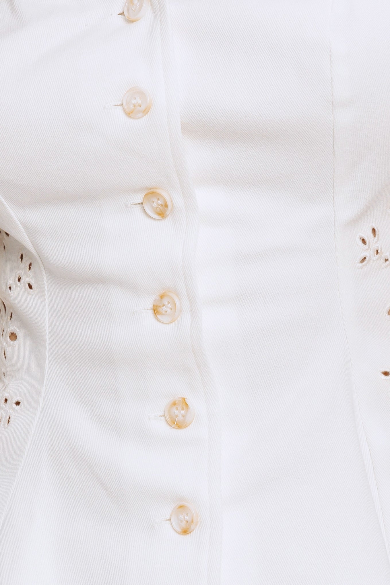 A solid top featuring sweetheart neckline, sleeveless, front button down and embroidered eyelet detail

Details:

Self: 97% Cotton 3% Spandex

Size & Fit

-Model is 5`8" And Wearing Size Small
-Measurements Taken From Size Small
-Approx. Length: 20"