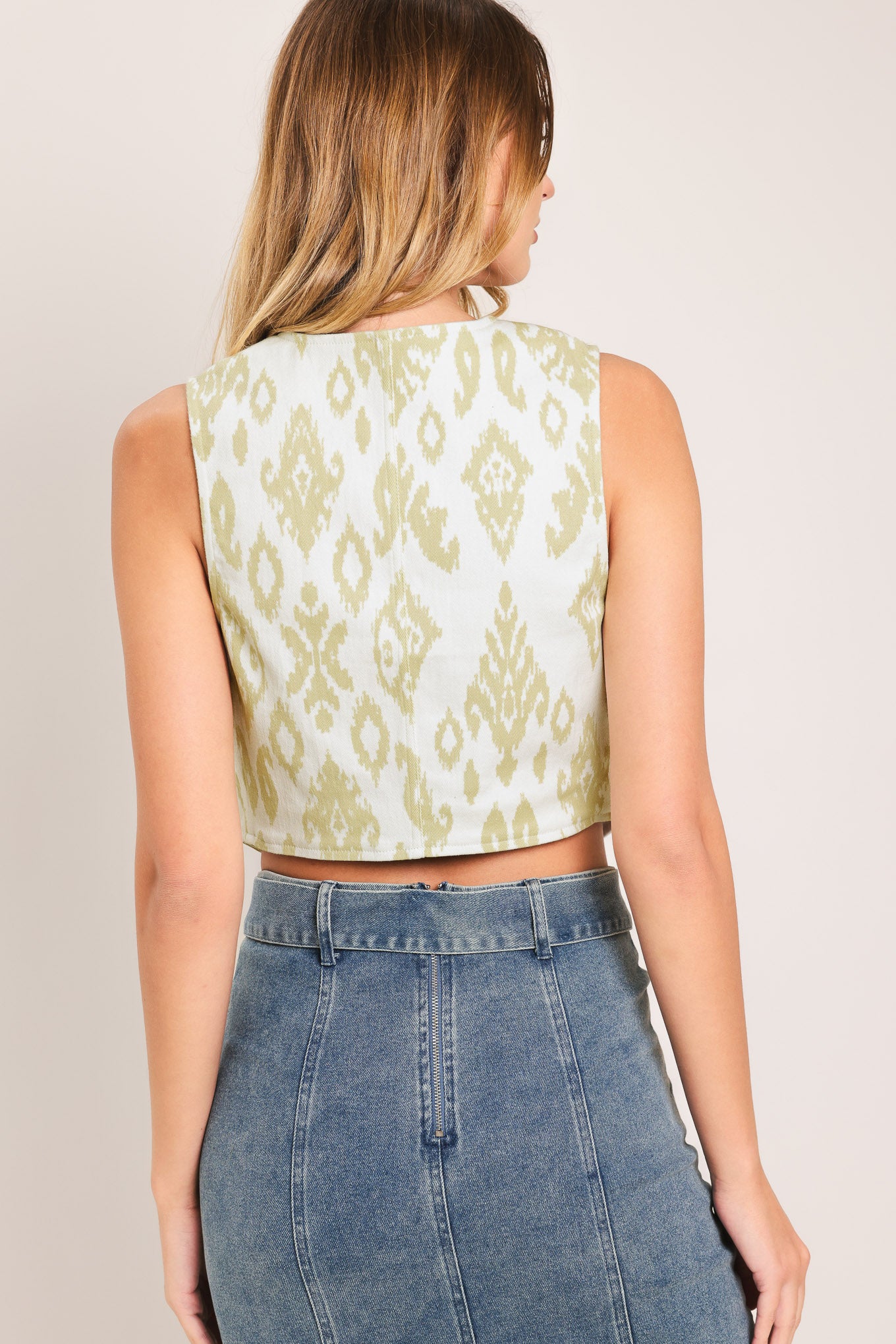 Woman wearing a ikat printed vest with front button down | Flying Tomato
