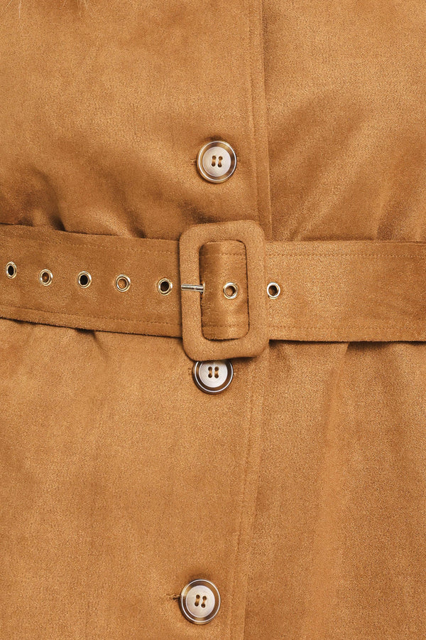 Woman wearing a camel suede capelet jacket with a collar, buttons, and matching  waist belt | Flying Tomato