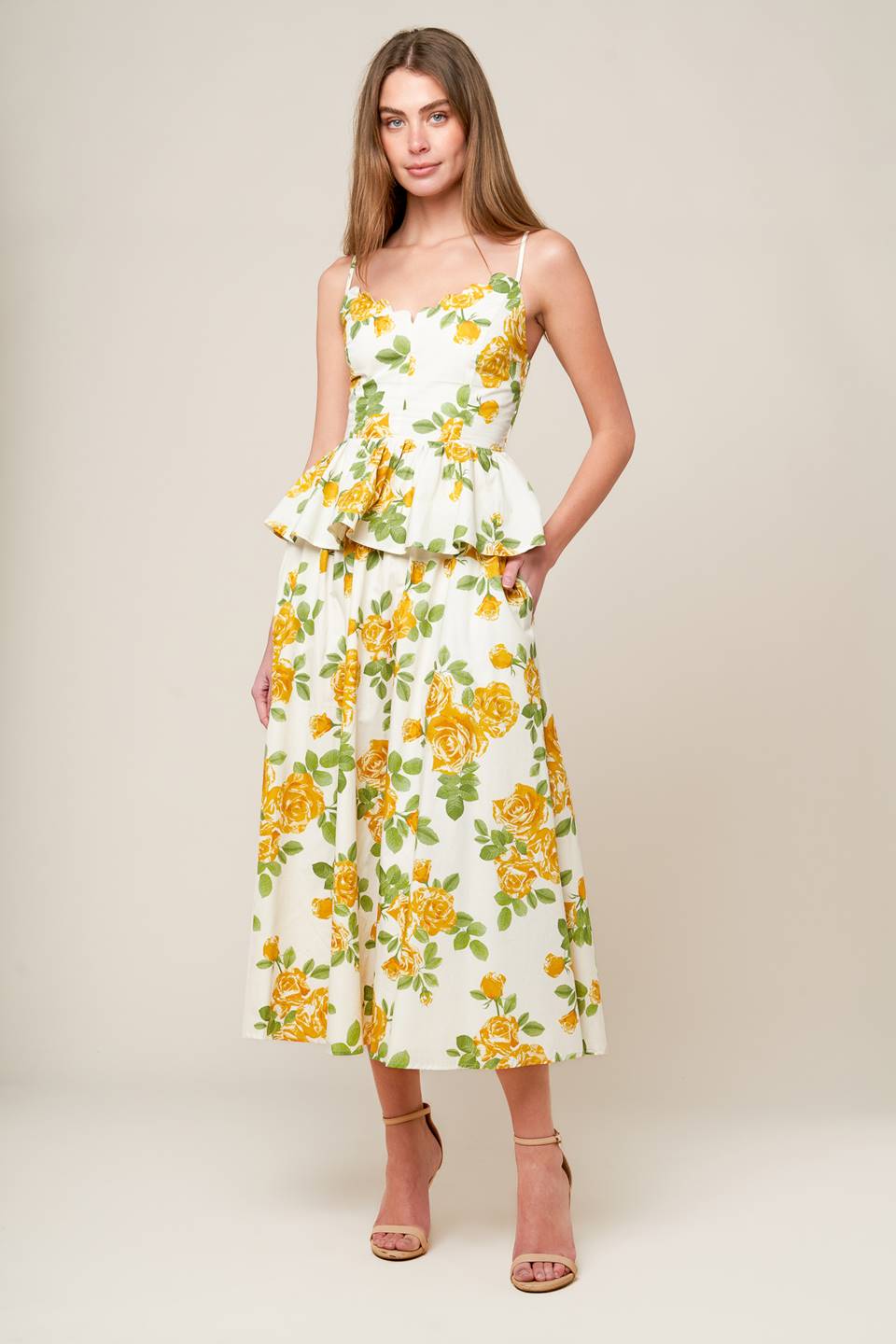 A cream woven full skirt featuring yellow floral print, side zipper closure and pockets.