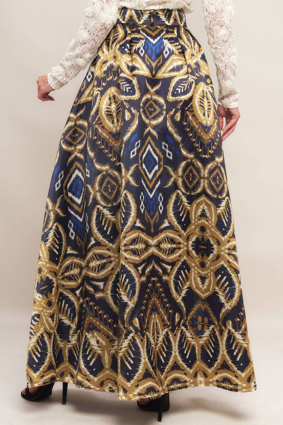 A printed woven maxi full skirt with side zipper closure and self belt.