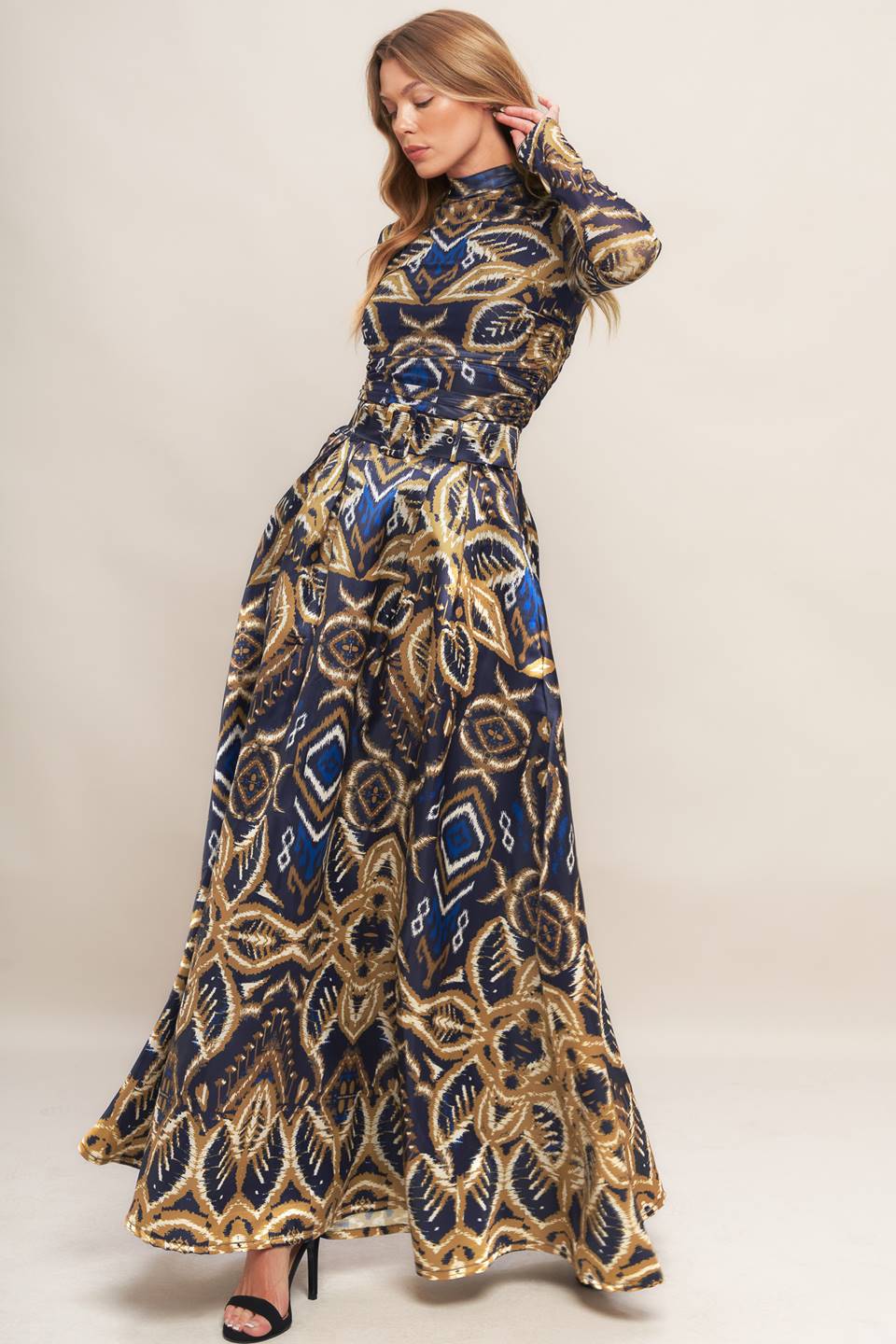 A printed woven maxi full skirt with side zipper closure and self belt.