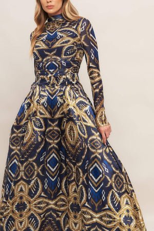A printed woven maxi full skirt with side zipper closure and self belt.