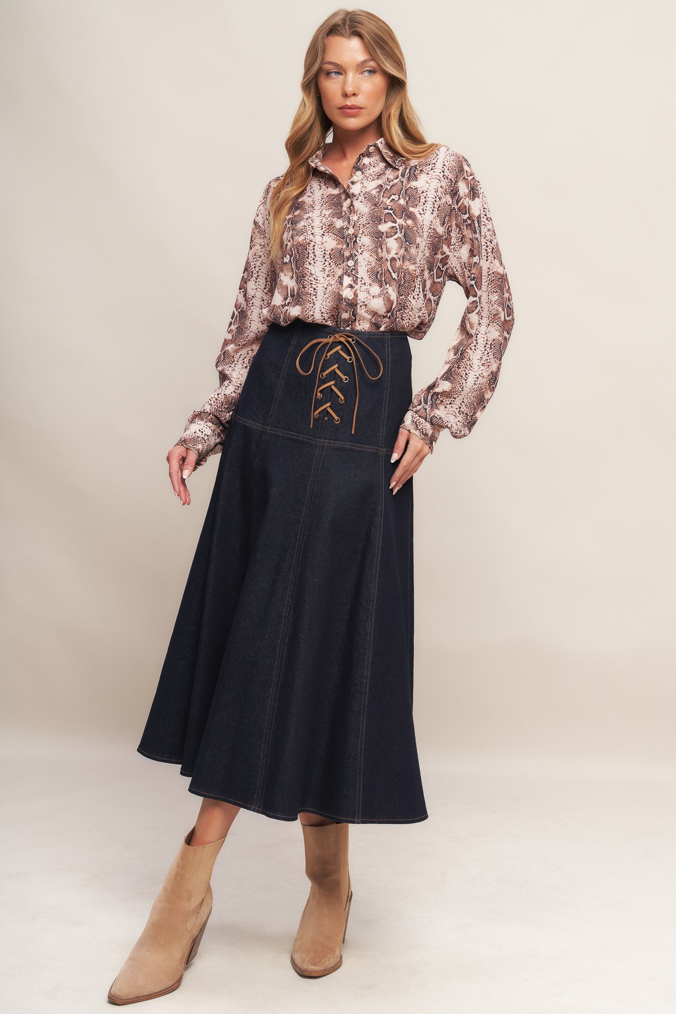 A denim midi skirt featuring front lace up detail and back zipper closure