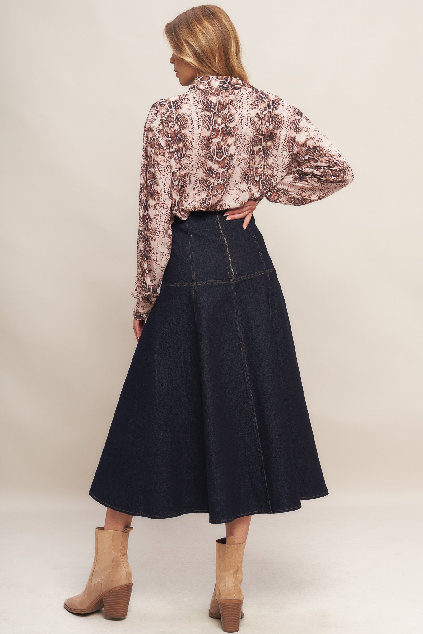 A denim midi skirt featuring front lace up detail and back zipper closure