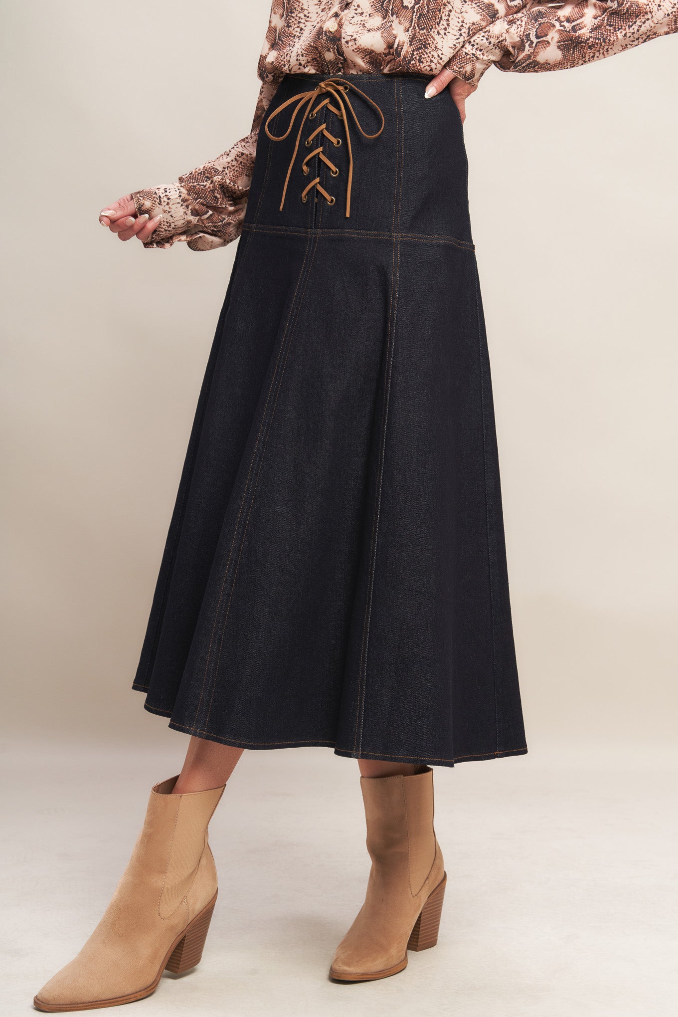 A denim midi skirt featuring front lace up detail and back zipper closure