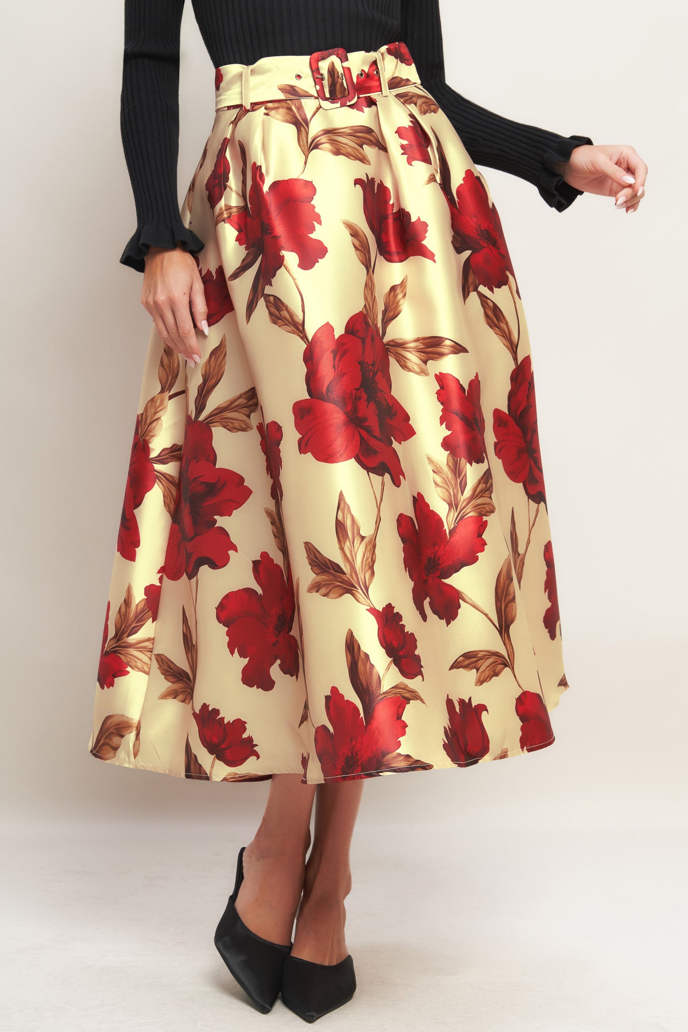 A printed woven midi skirt with self belt and side zipper closure.
