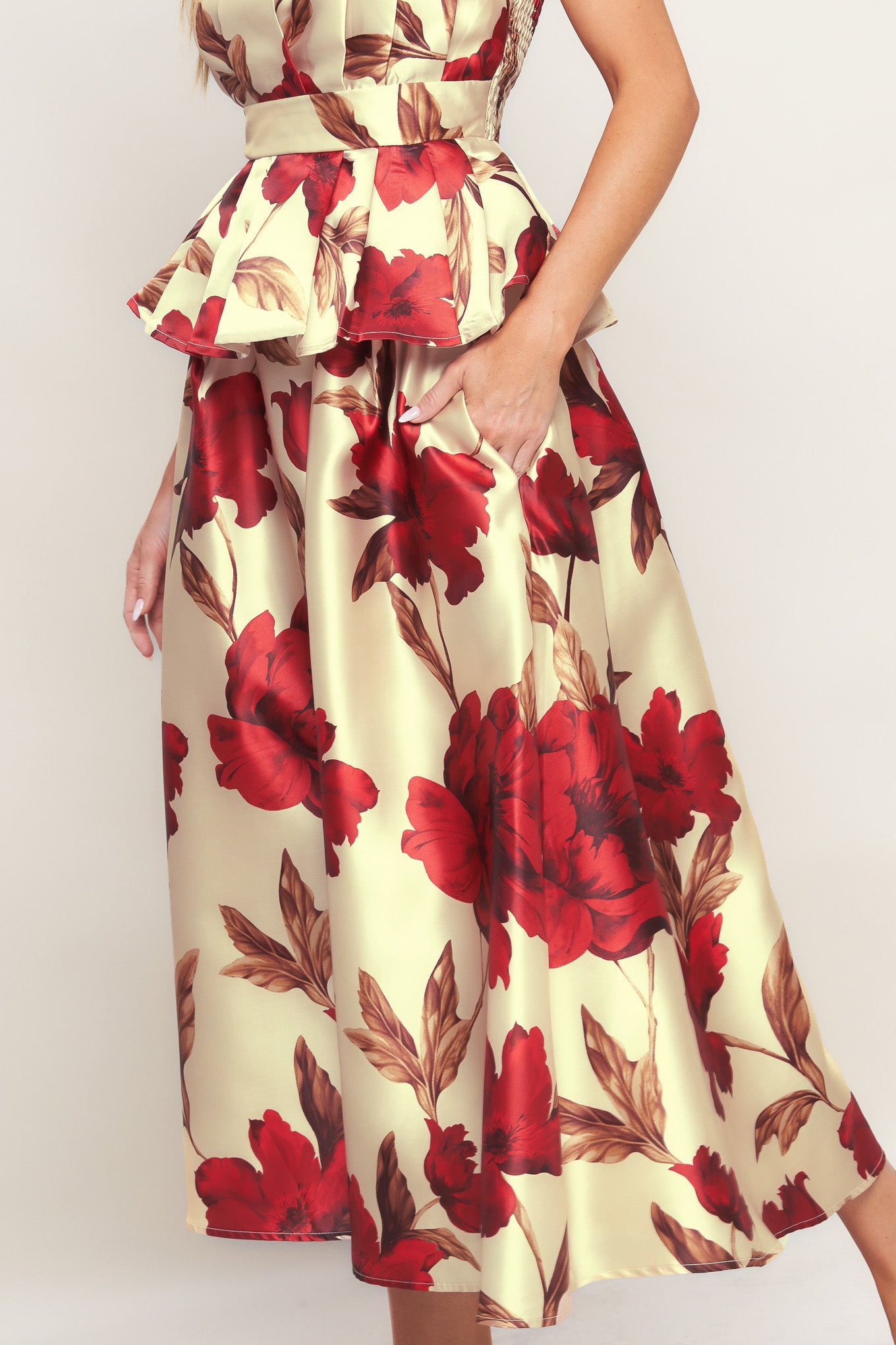 A printed woven midi skirt with self belt and side zipper closure.