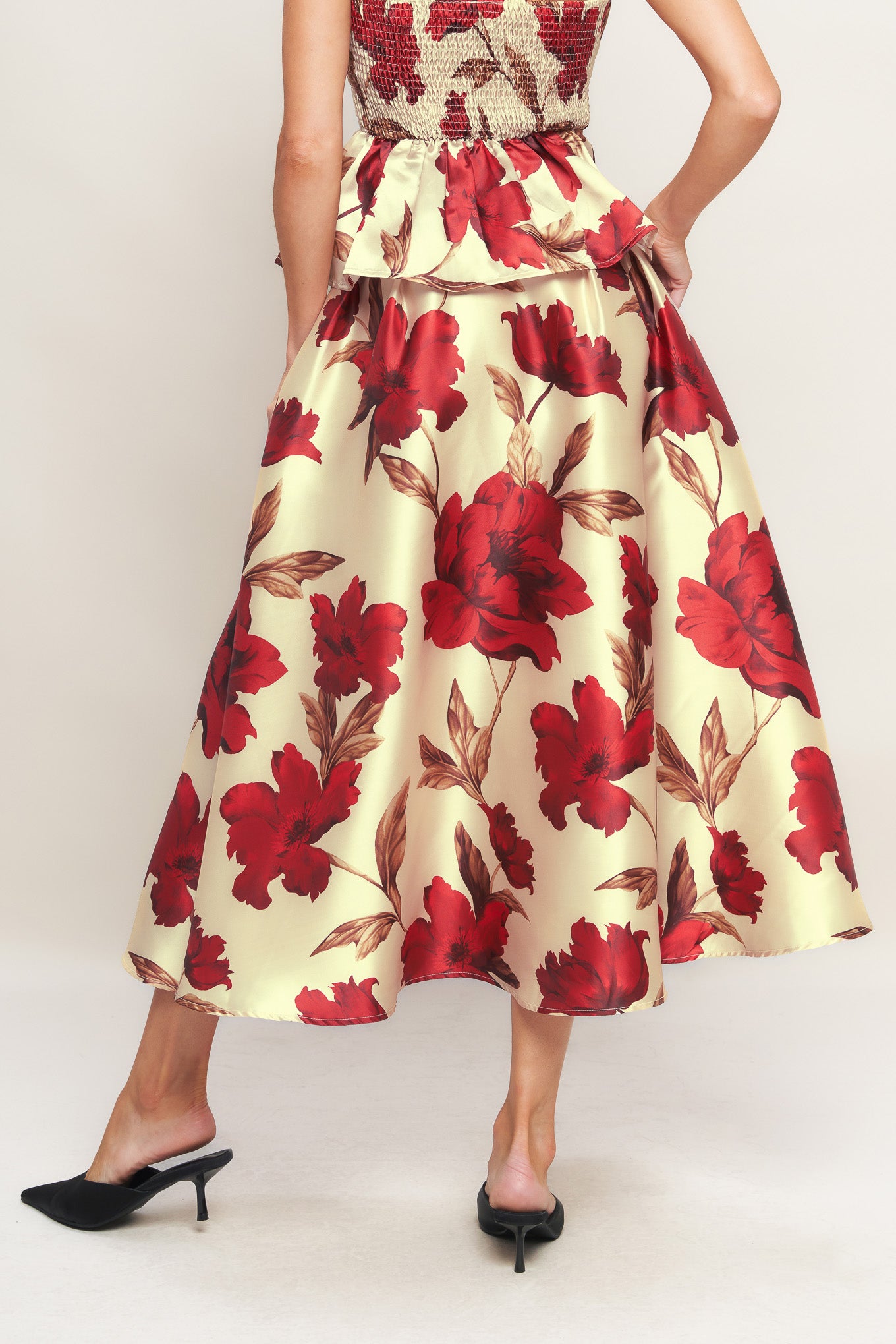 A printed woven midi skirt with self belt and side zipper closure.