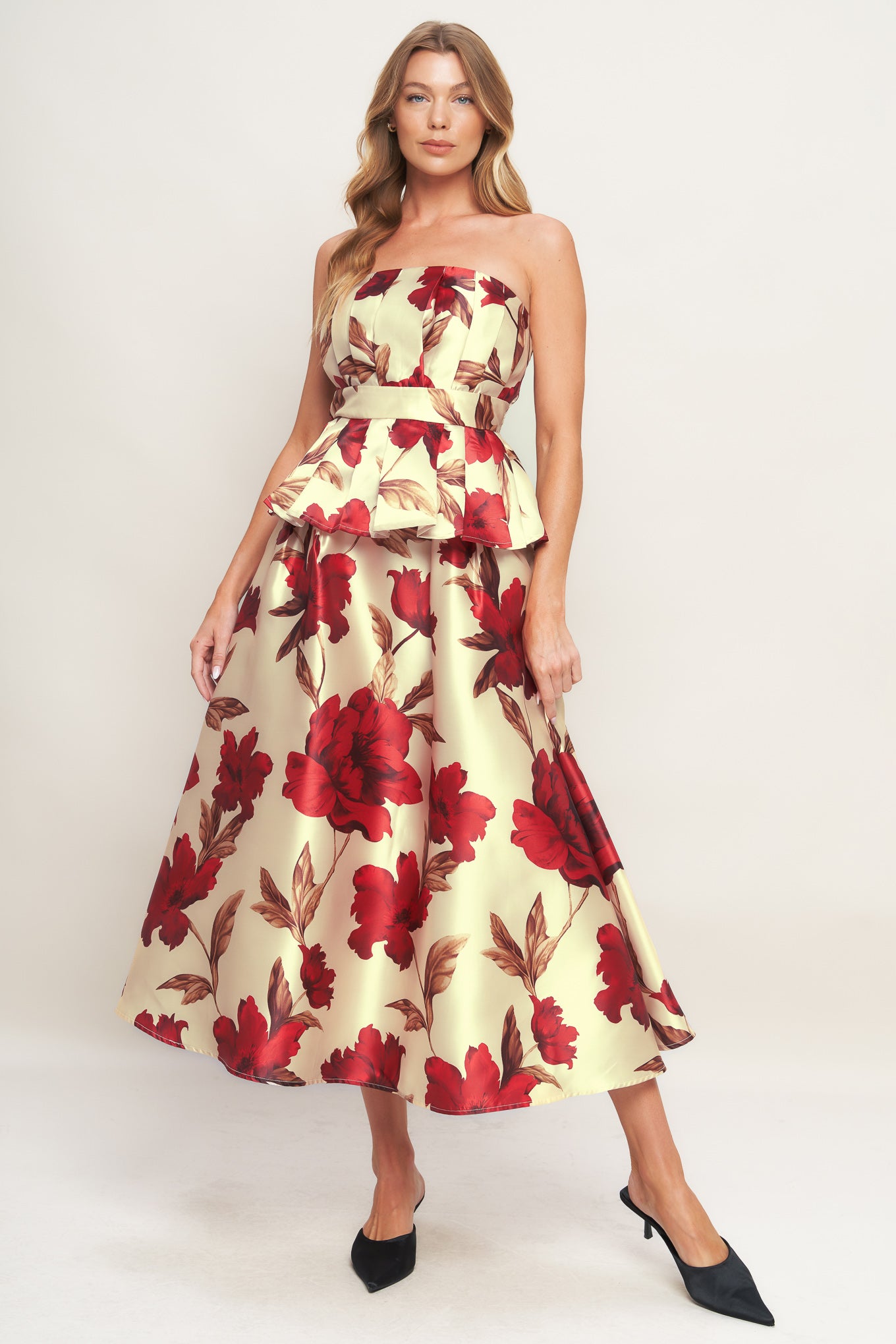 A printed woven midi skirt with self belt and side zipper closure.